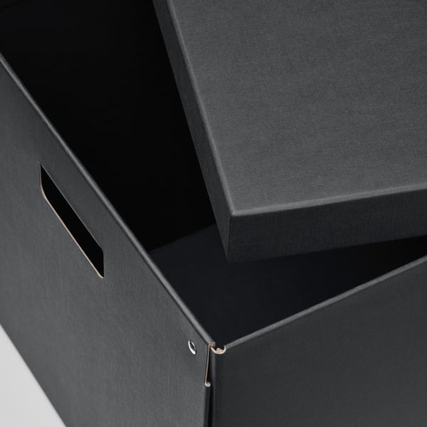 Black sturdy cardstock box with cut-out handles, partially open, showcasing quality and durability.