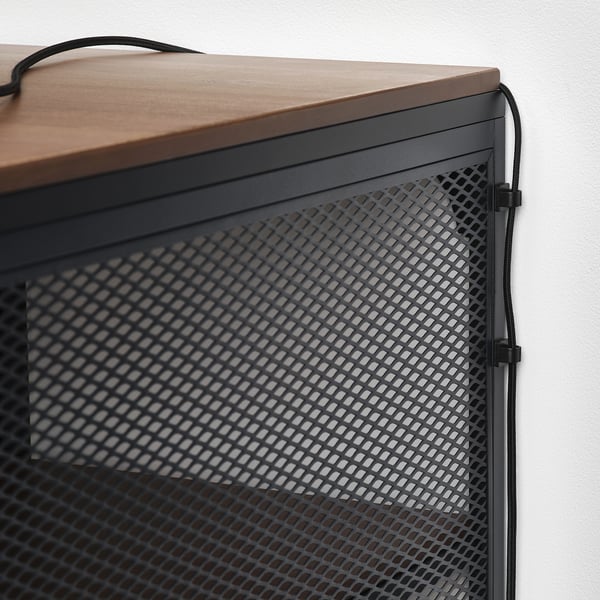 Desk with cable management: wood top, metal mesh back, self-adhesive clips for cord organisation.