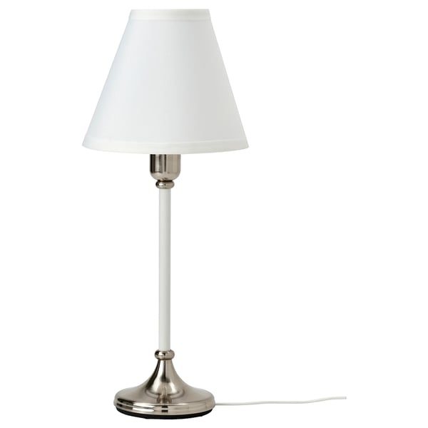 A FLYGHÖJD lamp with a white shade and nickel base, standing elegantly on a white background.