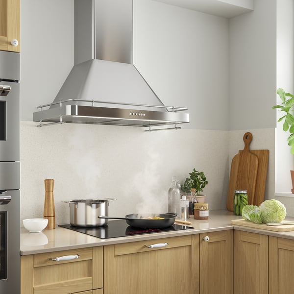 Modern kitchen with stainless range hood, led lights & sleek design.