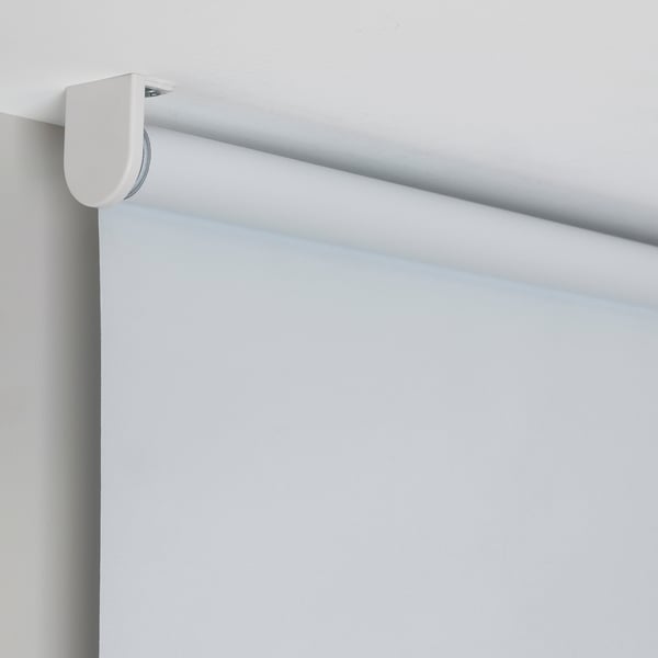 Cordless roller blind, mounted high, showing smooth operation and light block.