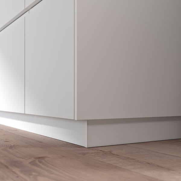 FÖRBÄTTRA white plastic kitchen cabinet plinth, sleek design, wood floor.