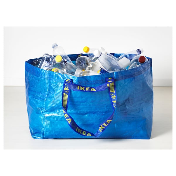 Blue ikea bag filled with plastic bottles for recycling.