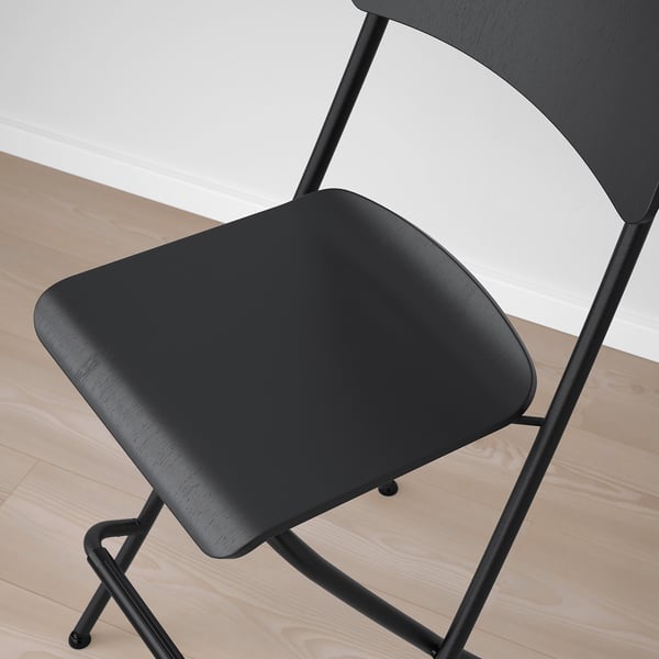 Black bar stool with wooden seat and metal frame; designed for stability and comfort.