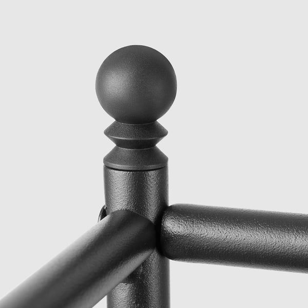 Black metal shelving detail: round finial top, textured surface, sturdy joint.