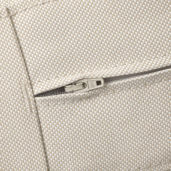 Close-up of zip on beige, textured outdoor cushion, showcasing quality and durability.