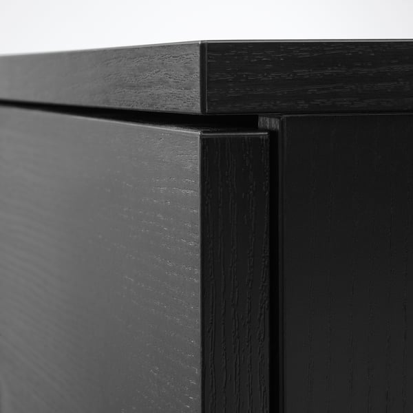 Black wooden furniture corner, showcasing smooth finish and craftsmanship, highlighting quality.
