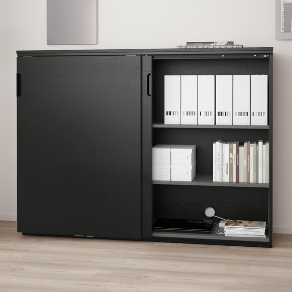 Black office cabinet with sliding doors for secure file storage, adjustable shelves, lock, cord management, stable.
