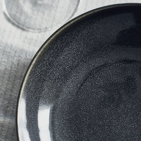 Dark grey glazed plate, smooth texture, unique crafting, deep design.