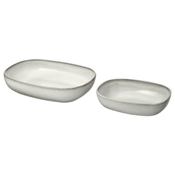 Two white ceramic oven dishes, slightly different sizes, sand-glazed, rectangular shape, simple and modern design.