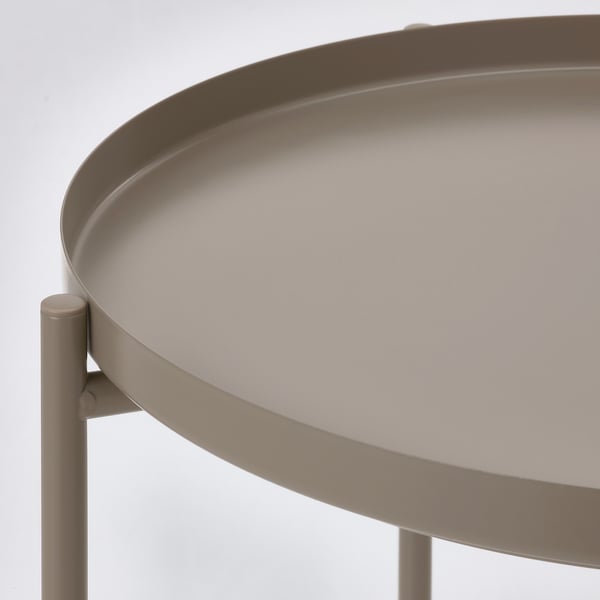 Round tray table, modern design. High-quality powder-coated steel, durable and easy to clean. Lightweight and portable, ideal for serving.