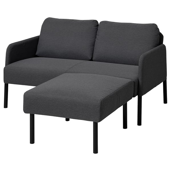 Dark gray modern sofa with matching ottoman, sleek metal legs, and clean lines.