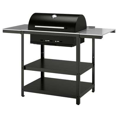 Black outdoor charcoal grill on stand with side shelves. Stainless steel and powder-coated steel construction; ideal for bbq parties.