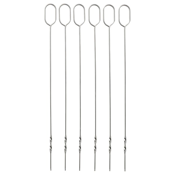 Six stainless steel skewers with oval handles laid out side by side.