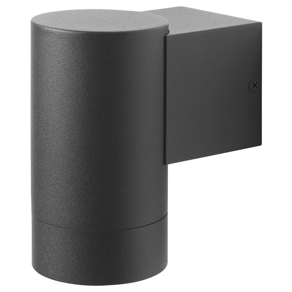 A black outdoor wall lamp named GRÖNSPRÖT with a cylindrical base and rectangular body, made of aluminium and stainless steel.
