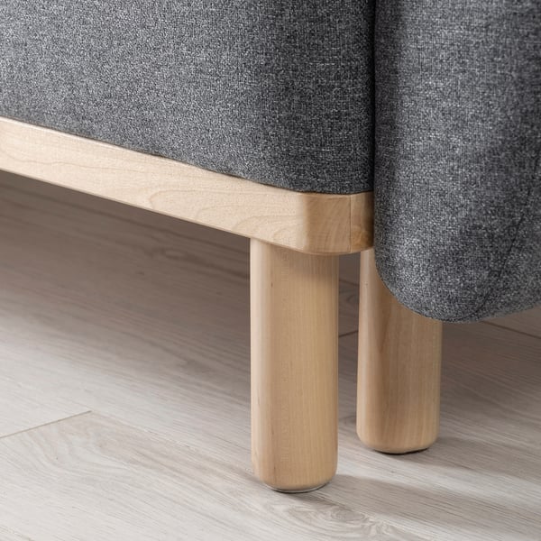 Modern grey sofa-bed with wooden legs, offering quality comfort and style.
