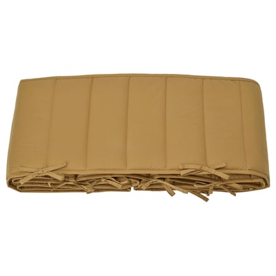 Beige GULDVÄVARE bed bumper, rectangular, padded, tied with ribbons for attachment.