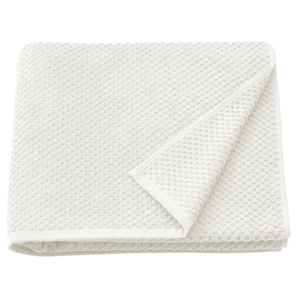 Folded beige GULVIAL towel, textured cotton.