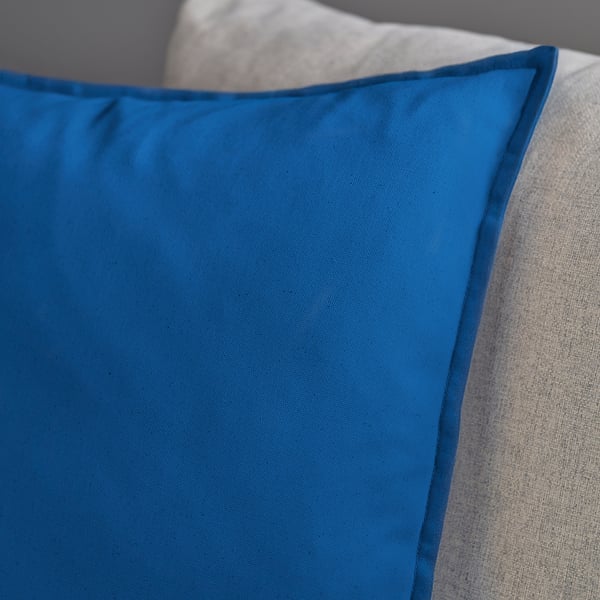 Close-up of smooth, bright blue GURLI cushion cover showcasing its soft fabric texture and neat stitching.