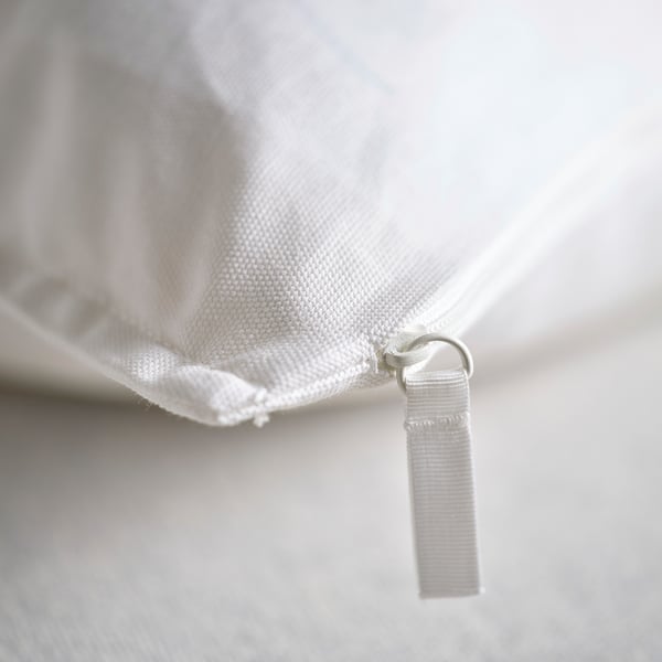 Close-up of GURLI pillow: quality cotton zip, smooth texture, pristine white.