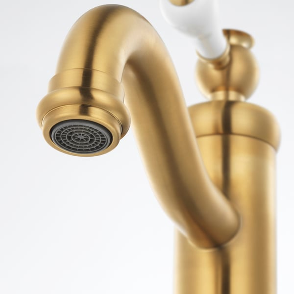 Golden tap with sleek curve, featuring a detailed aerator head, indicating high-quality build and design.
