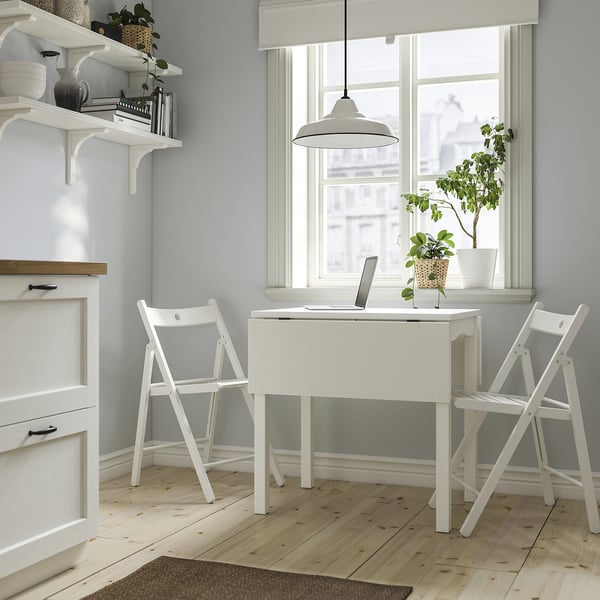 Small white HAUGA drop-leaf table & frösvi folding chairs. Perfect for small spaces, fits near a window next to shelves.