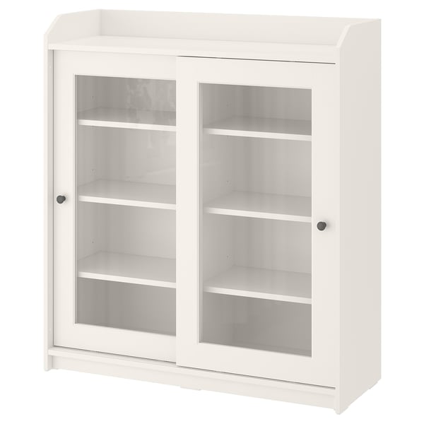 This image displays a white HAUGA cabinet with glass doors, ideal for displaying items. It has a classic design with a top shelf and sliding doors.