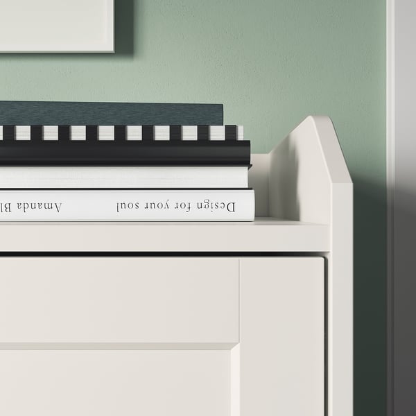 White HAUGA sideboard with books, minimalist design.