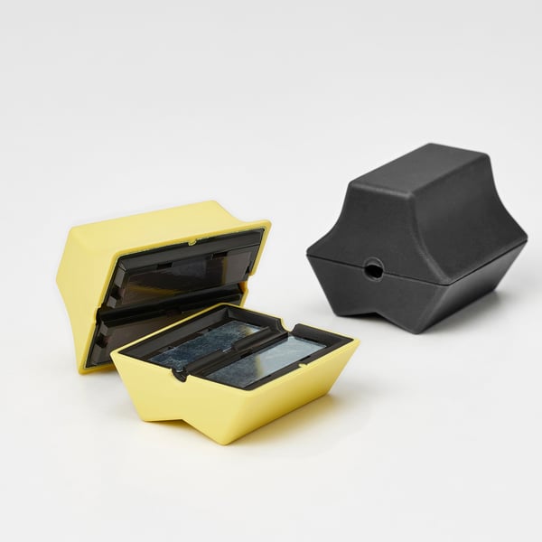 Two HAVSKÅL usb anchors, one yellow open revealing internal magnet, one black closed, showcasing quality design and materials.