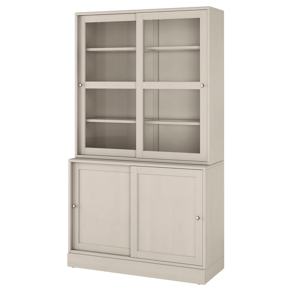 A light beige HAVSTA storage cabinet. It glass doors at the top and wooden cabinets below. The design is rustic with a brushed pine finish.