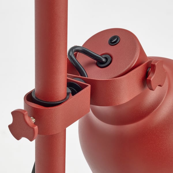 Red adjustable lamp with sturdy metal construction, featuring precision joints and robust knobs for easy height adjustment.