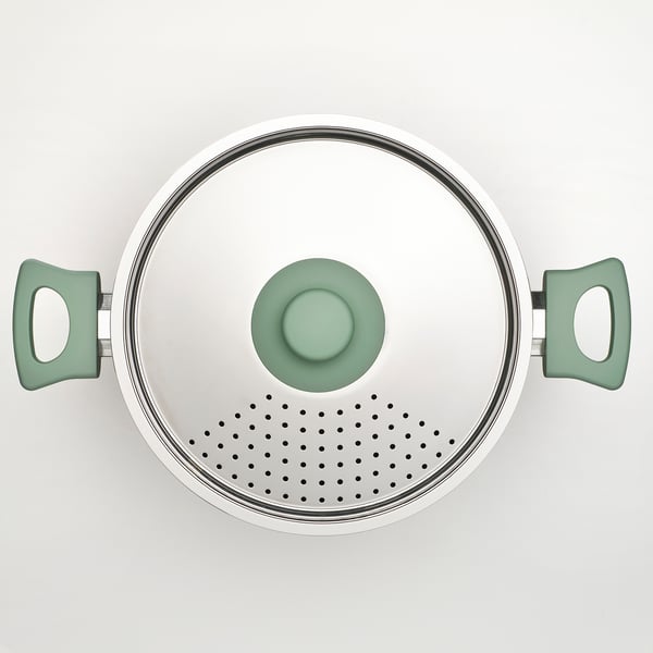 Modern pan with green handles and lid; non-stick, even heat distribution.