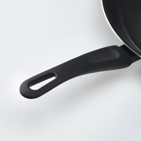 Close-up of black pan handle, sleek design, excellent grip, nonstick coated pan body visible.