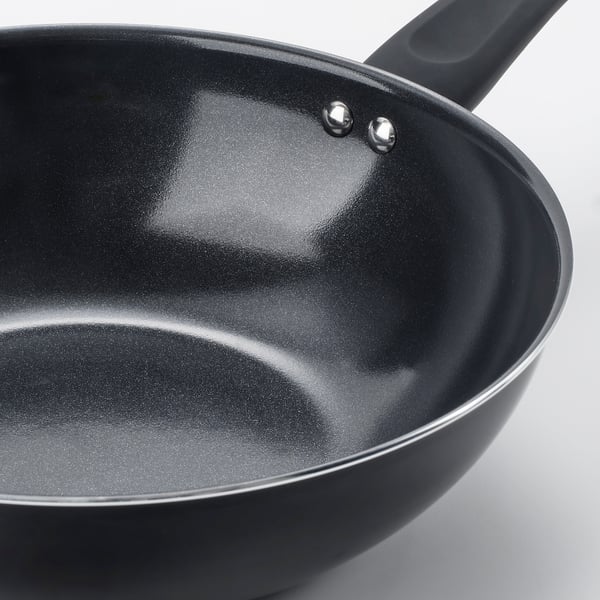 Black non-stick wok with two sturdy handles and smooth interior, ideal for cooking without spills.