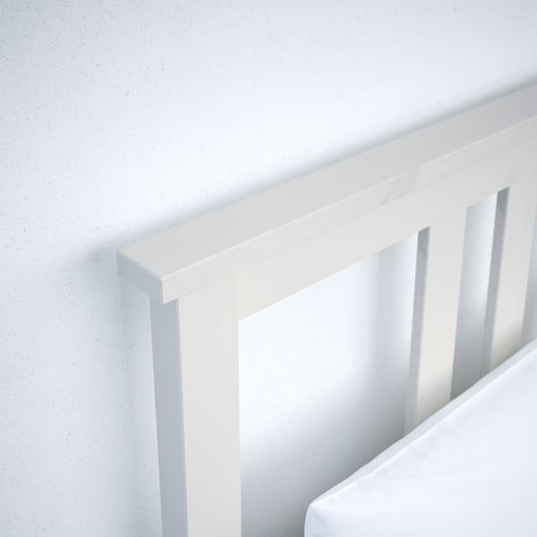 Thoughful close-up of white wooden bed frame showcasing clean lines and solid craftsmanship.