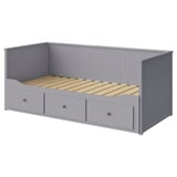 Grey HEMNES day-bed with drawers, wooden frame, upholstered base, rectangular shape, and vertical panel design.