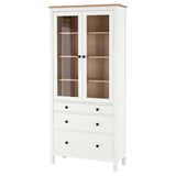 White HEMNES wooden cabinet with glass doors and drawers. Solid pine, rectangular shape.