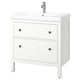 A white HEMNES bathroom vanity with two drawers and a ceramic sink. It has black knobs and a chrome faucet.