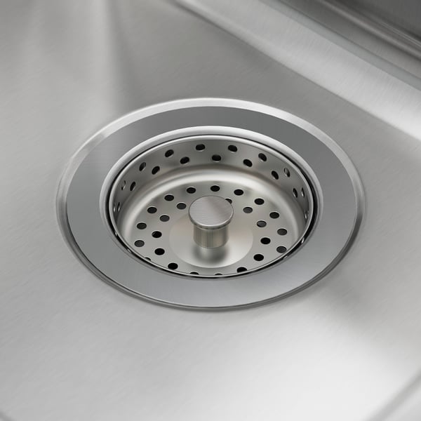 Close-up of a sleek, stainless steel sink drain with a strainer, showcasing its modern, polished design.