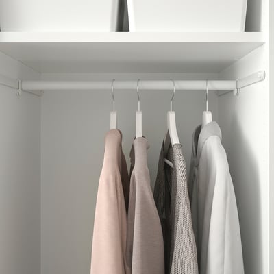 Closet with hanging hooks organising sweaters on rail.