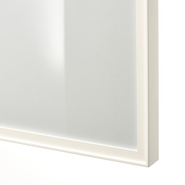Close-up of sleek, white HÖGBO door edge showing crisp corner finish and smooth glass surface.