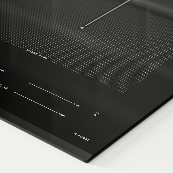 Modern black glass induction hob with touch control, featuring multiple heat zones and sleek design.