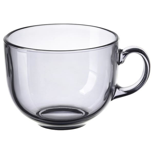 Single, transparent grey glass cup with small handle, round shape.