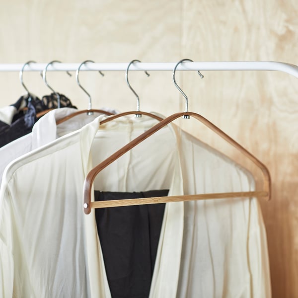 HÖSVANS hangers in natural bamboo. Slim, curved design for shirts and blouses, organises wardrobe efficiently.