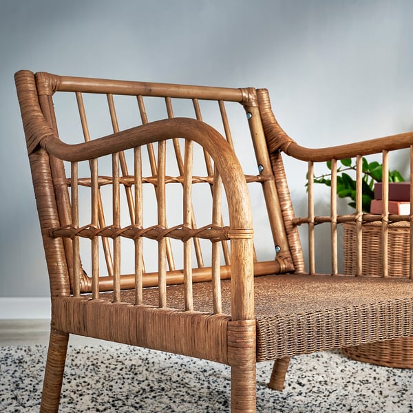 Wicker armchair with bamboo & wood, showcasing intricate craftsmanship. Light brown, comfortable, brings nature home.
