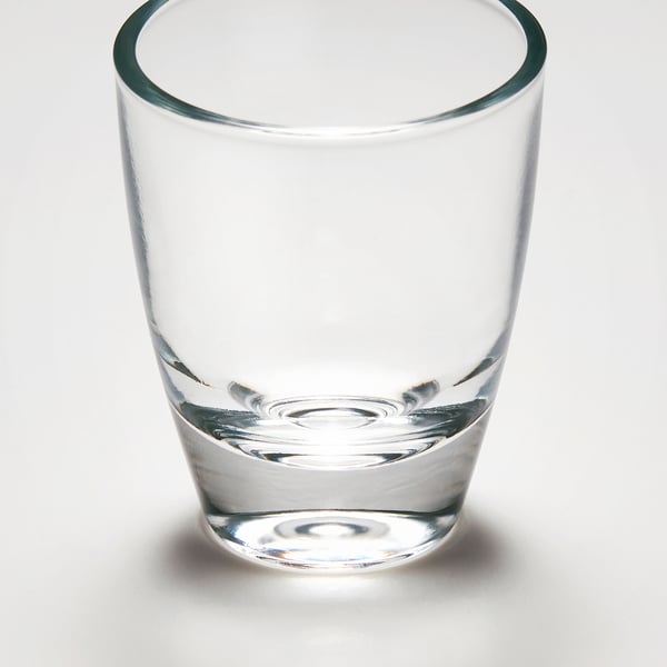 Small, clear glass, well-made, stands firmly, ideal for shots.