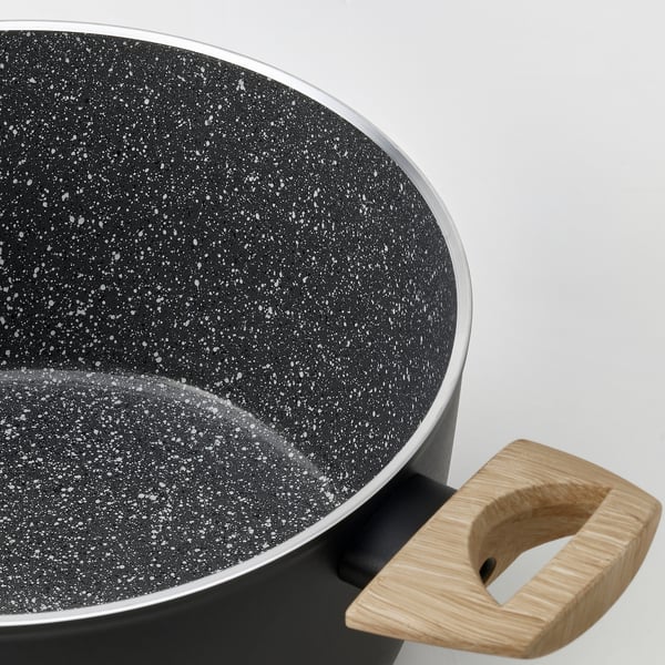 Modern cookware with non-stick coating, wooden handle, sleek design.