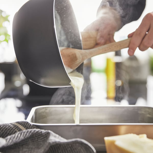 Pouring cream into tray, using non-stick pan.