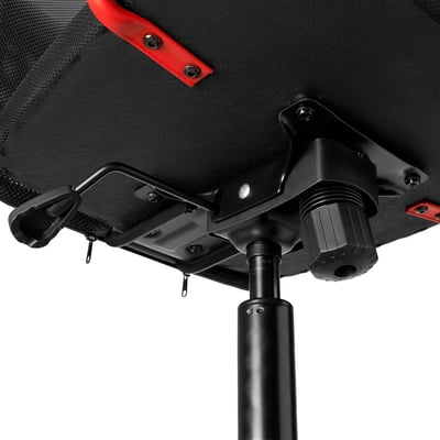 Black office chair with red accents, adjusting height and tilt mechanism visible.
