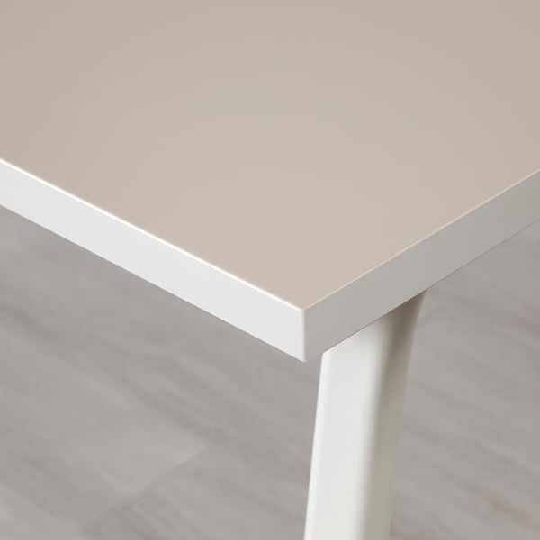 Clean, minimalist gaming table corner with pristine white top and leg. Surface smooth and uncluttered, reflecting quality design.